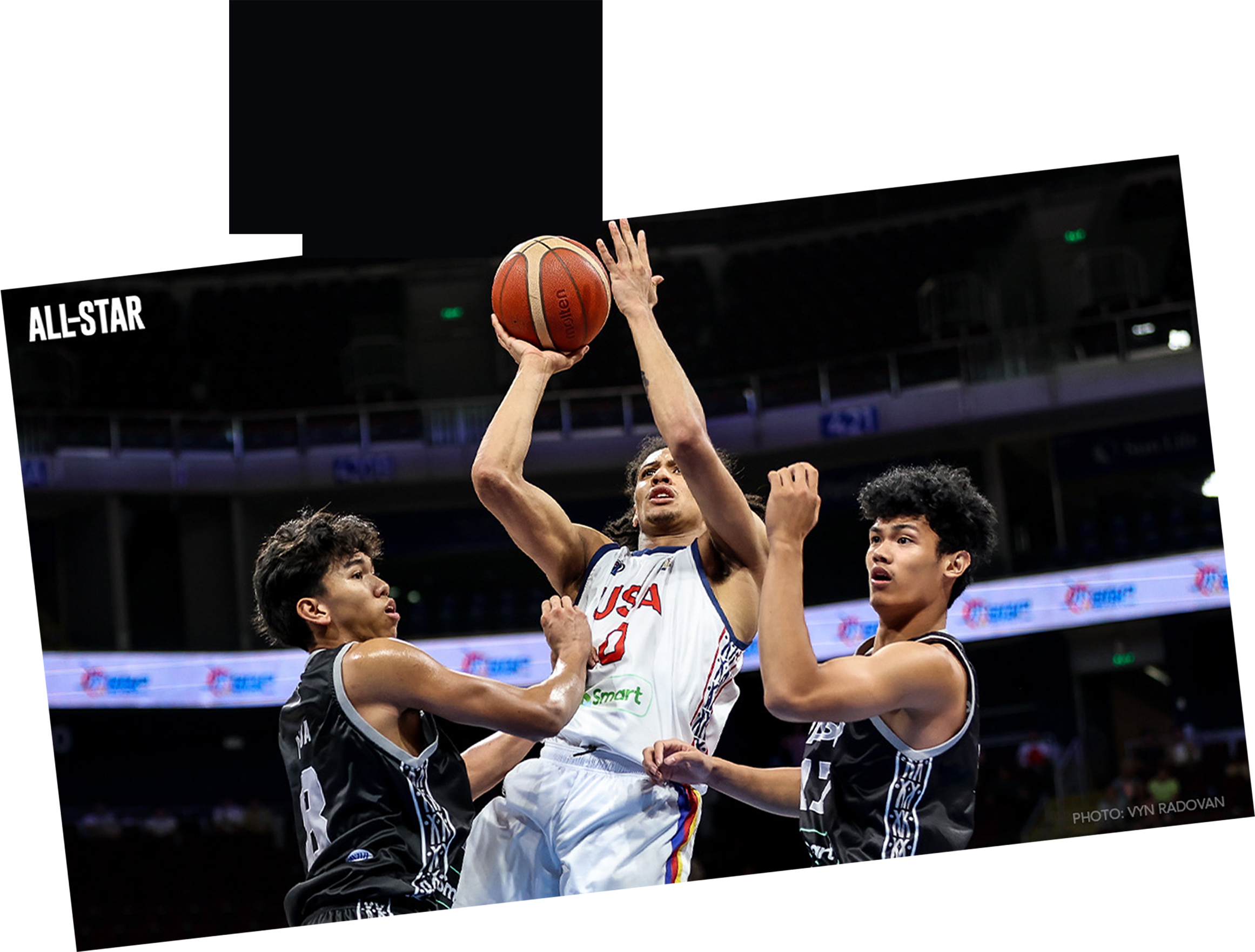 Basketball players competing under the rim